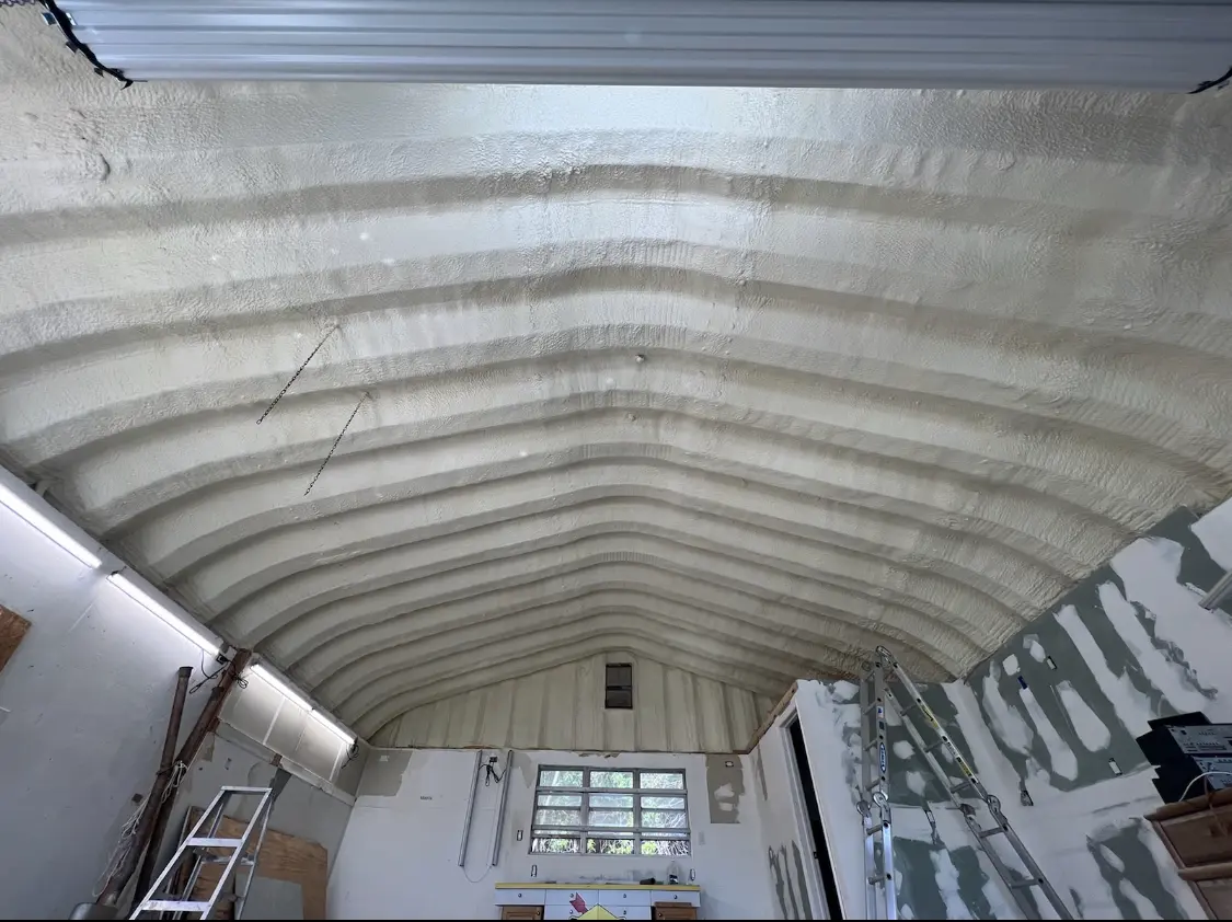 Spray polyurethane foam applied to the underside of a metal roof deck in Allen